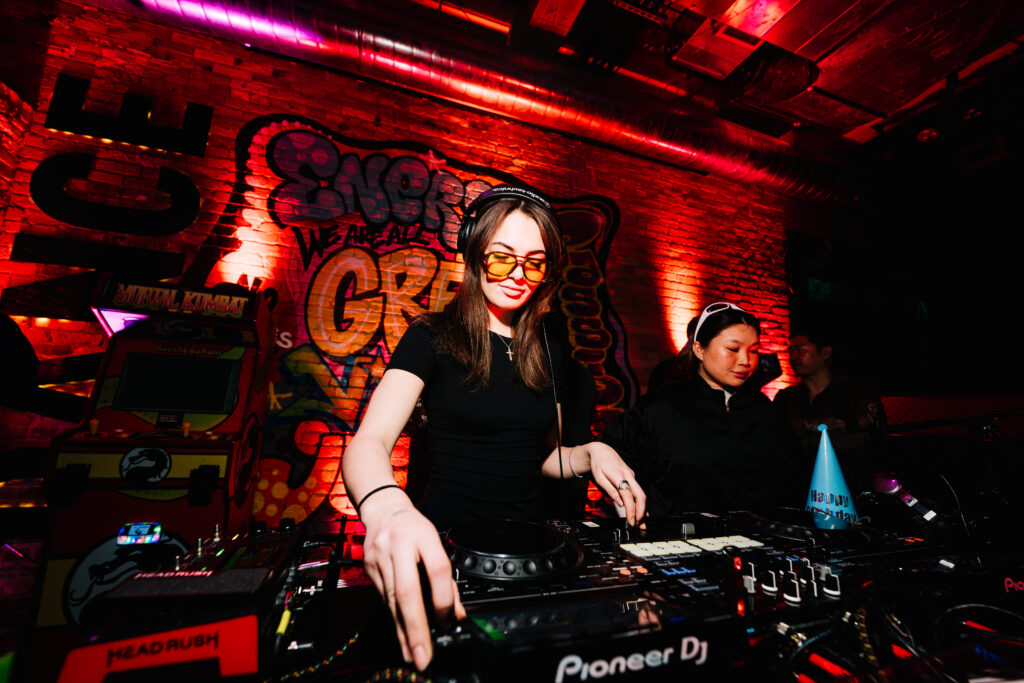 People dancing and enjoying music during late-night events at Greta Bar