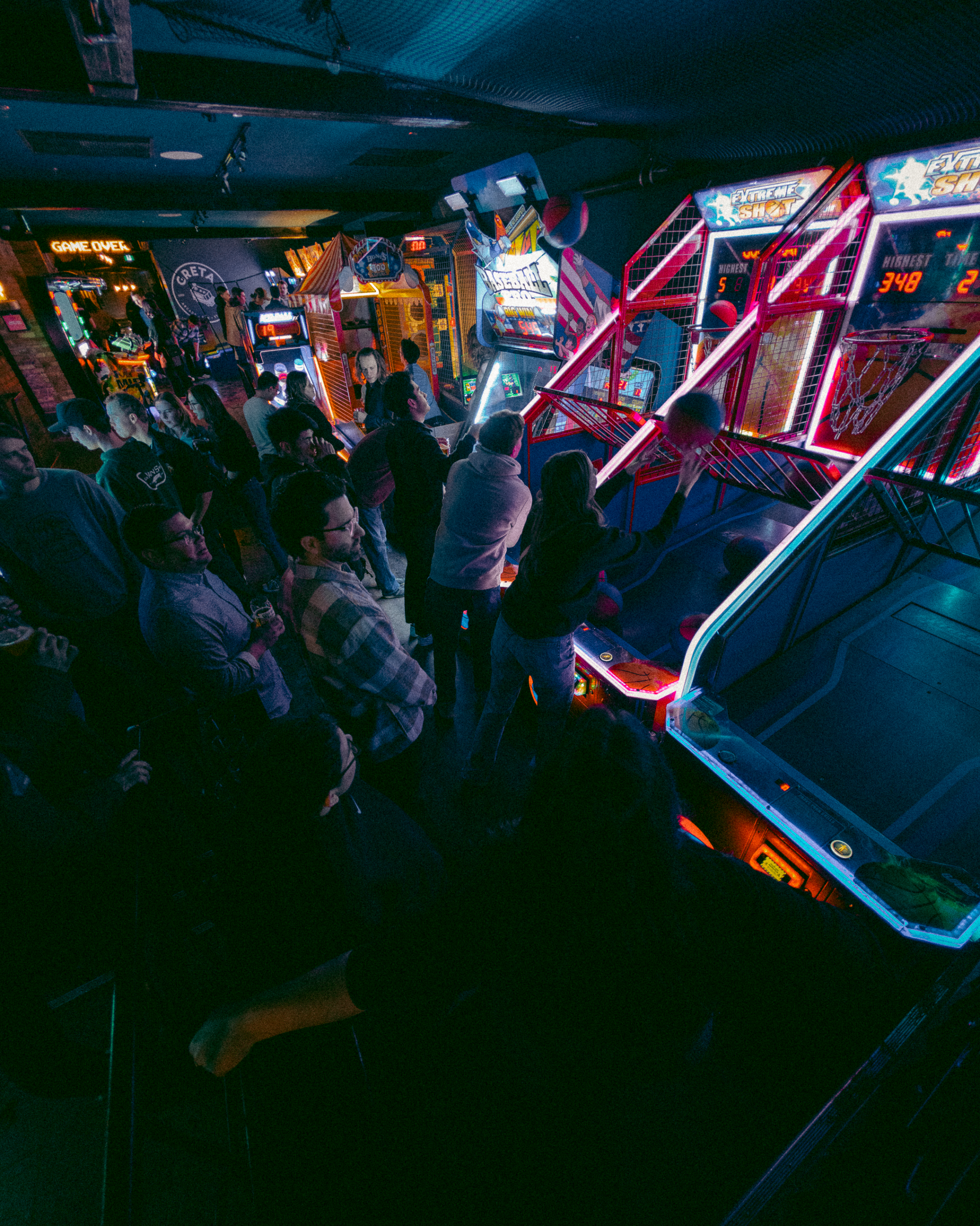 Guests playing arcade games and enjoying the entertainment at Greta arcade bar