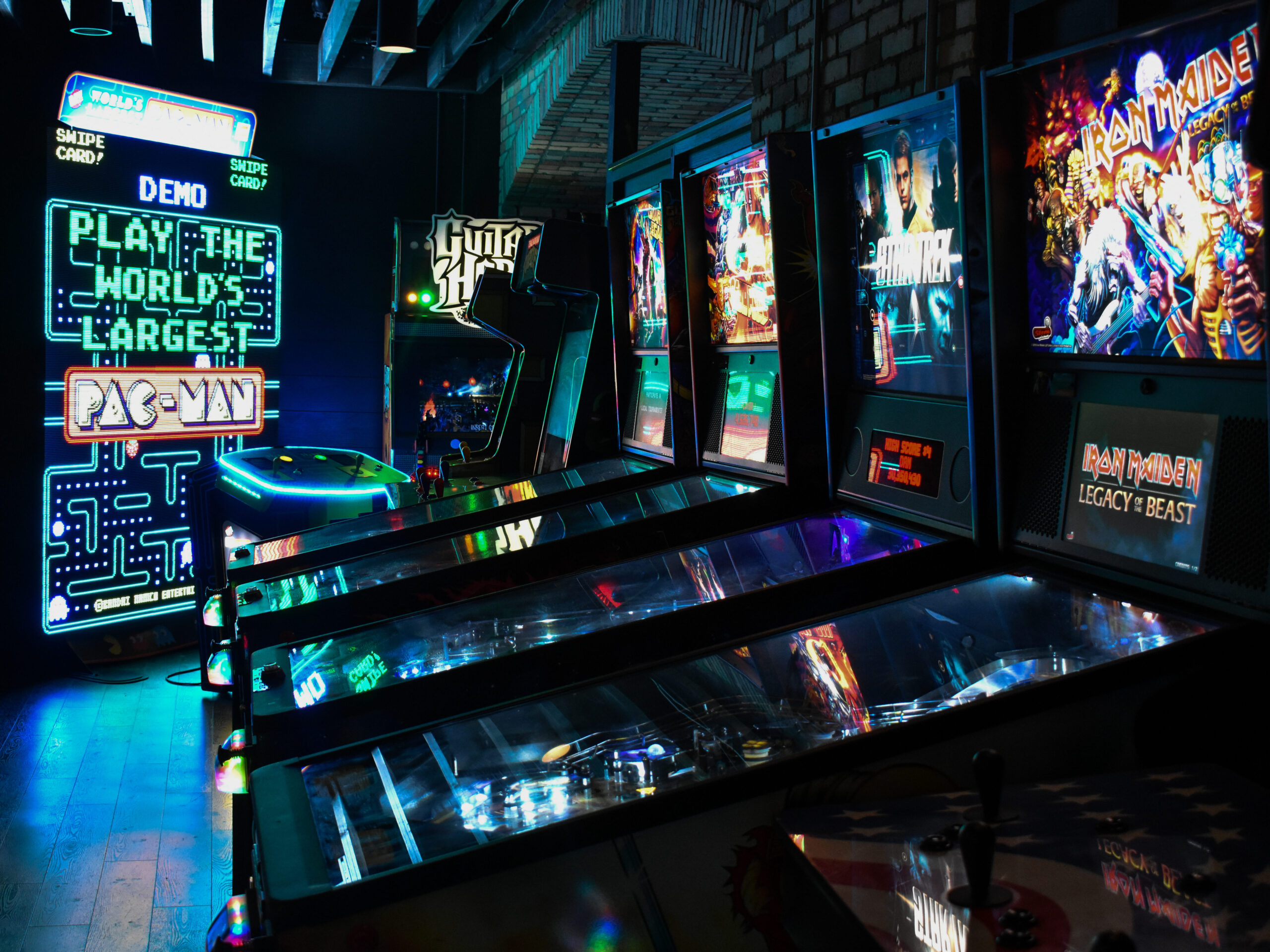 Guests playing arcade games and enjoying the entertainment at Greta arcade bar