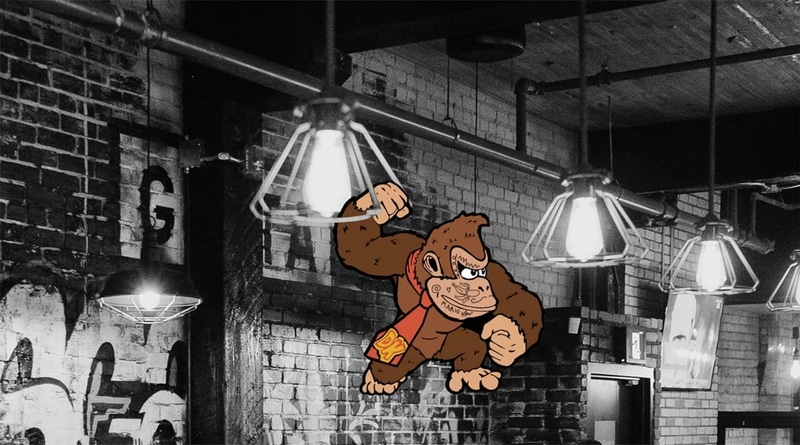 Videogame character DK swinging from a light at Greta Bar